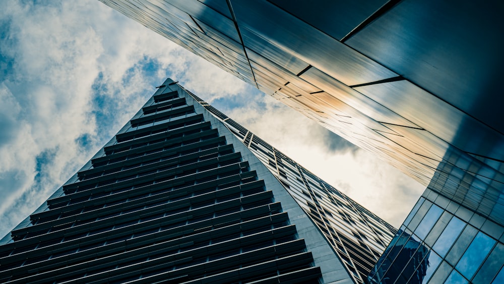 worms eye view of black building under cloudy sky during daytime