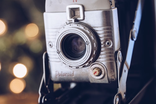 Close-up of a vintage camera with futuristic holographic overlays.