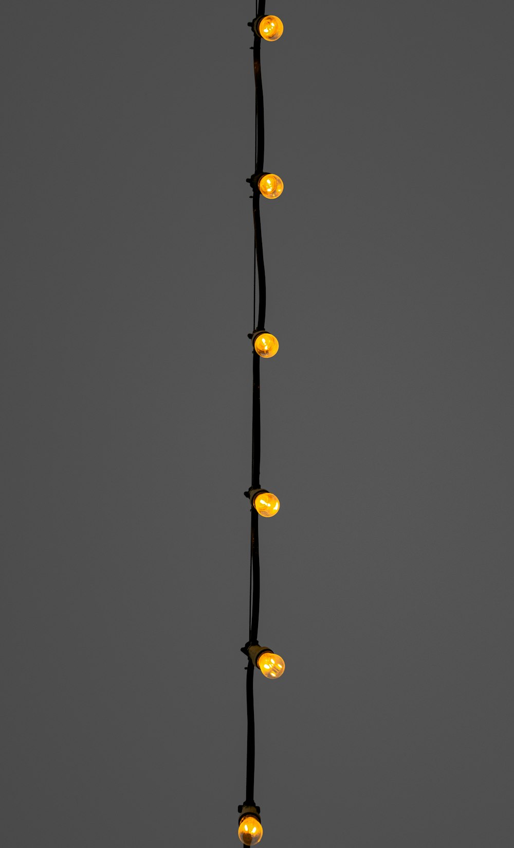 yellow string lights on black background
