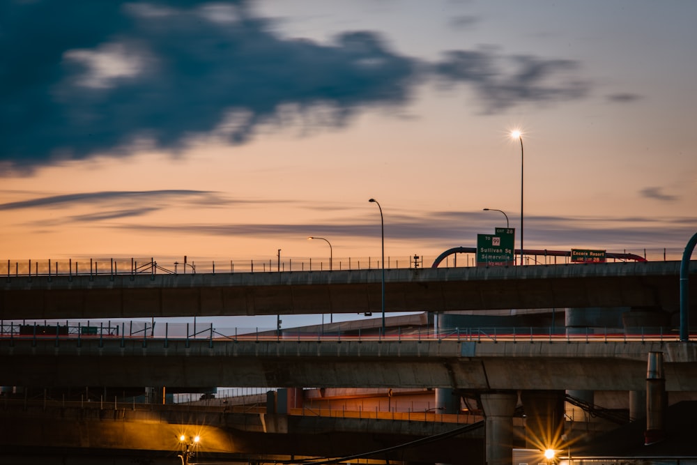 gray concrete bridge under gray clouds during daytime