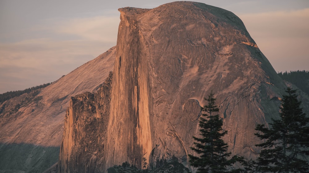 brown rock formation under white clouds during daytime