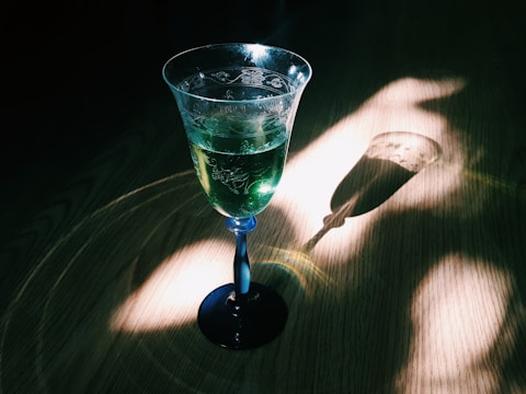 Laboratory glassware with green botanical extracts glowing softly under natural light.