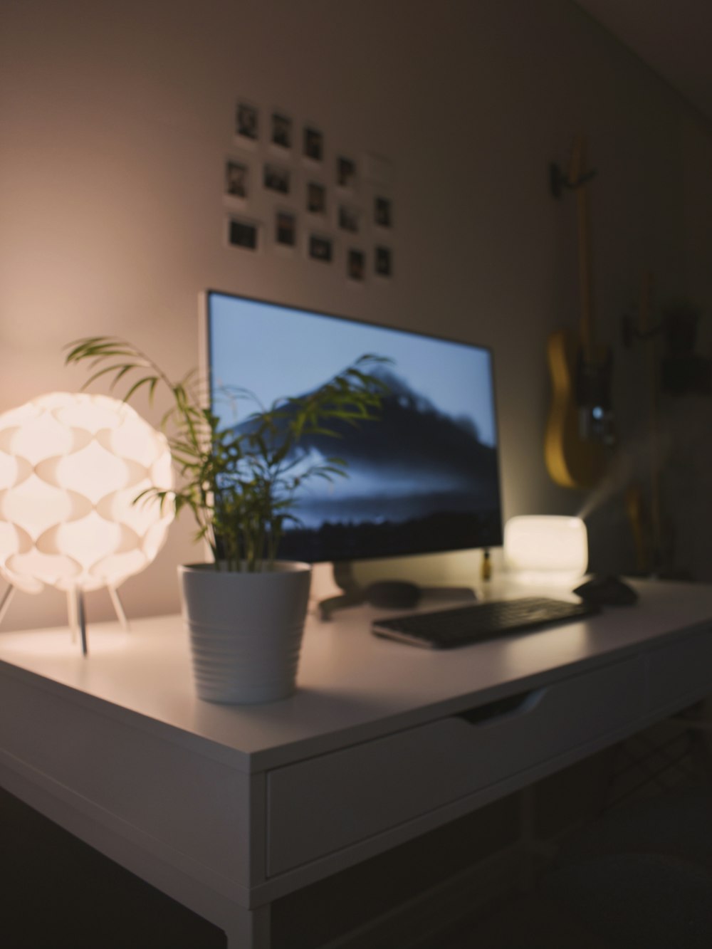 black flat screen tv turned on near white table lamp