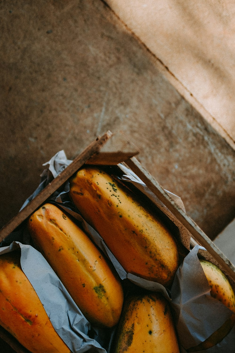 yellow banana fruit on brown cardboard box