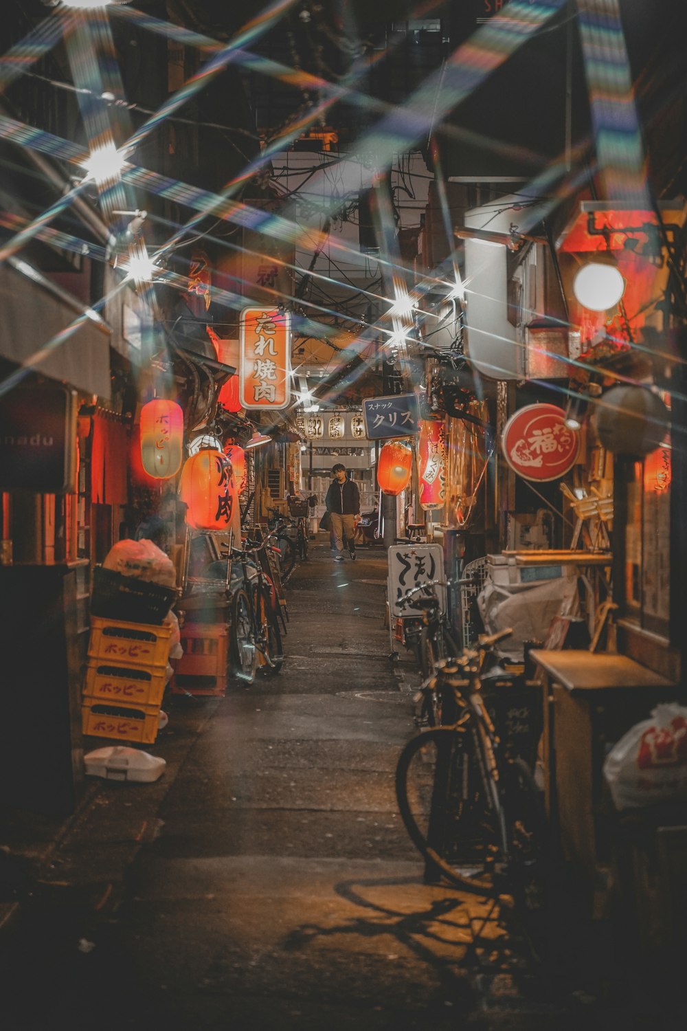 black bicycle parked beside store during night time