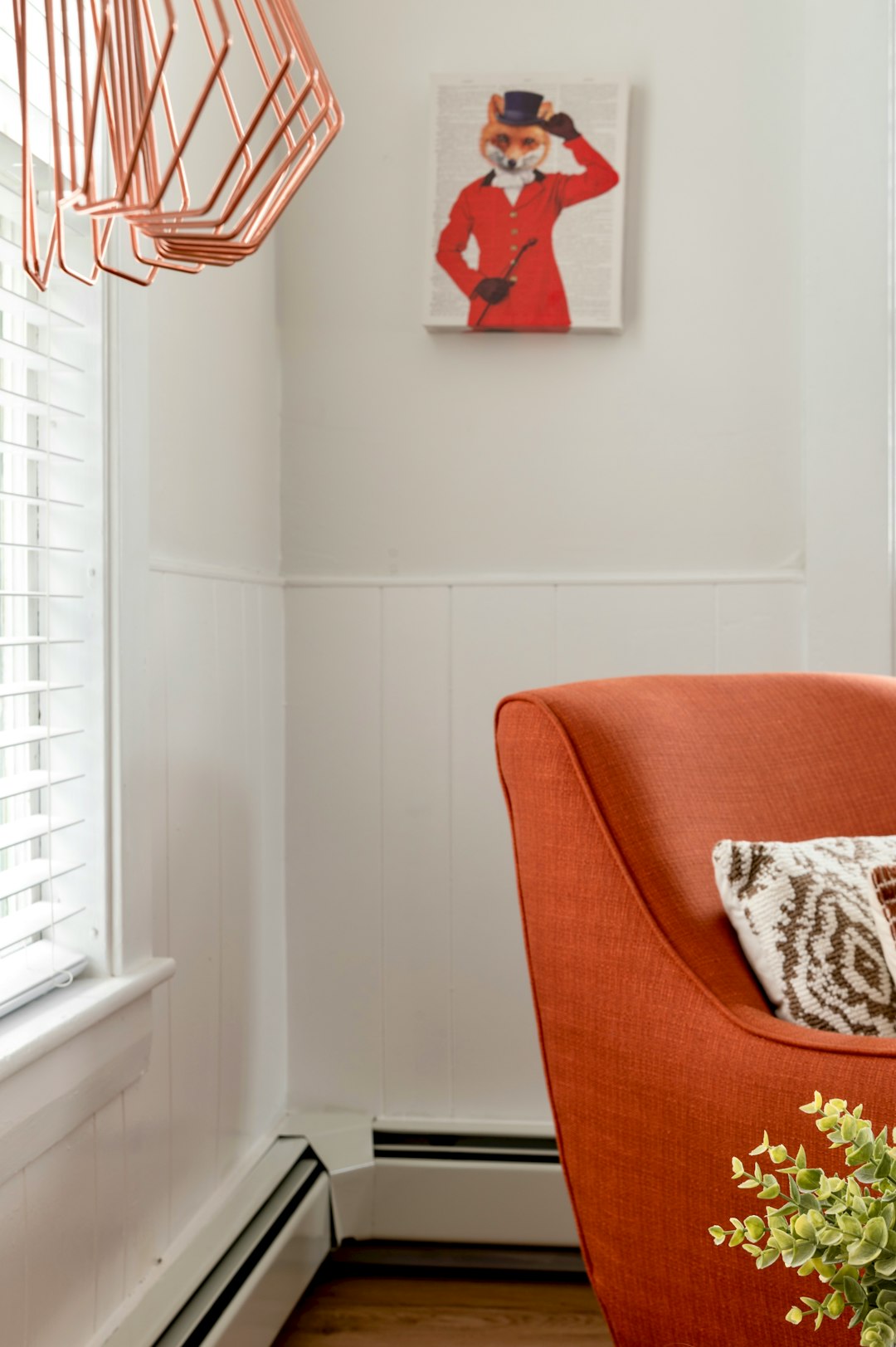 brown and white throw pillow on orange sofa chair