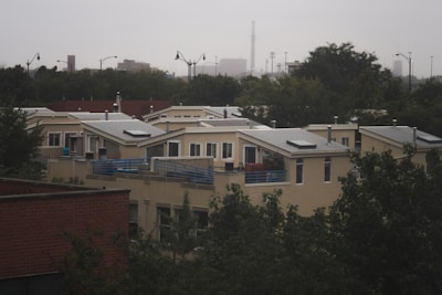 A modern residential neighborhood with newly built homes and green spaces under a clear sky.