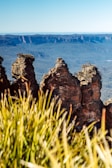 brown rock formation on body of water during daytime