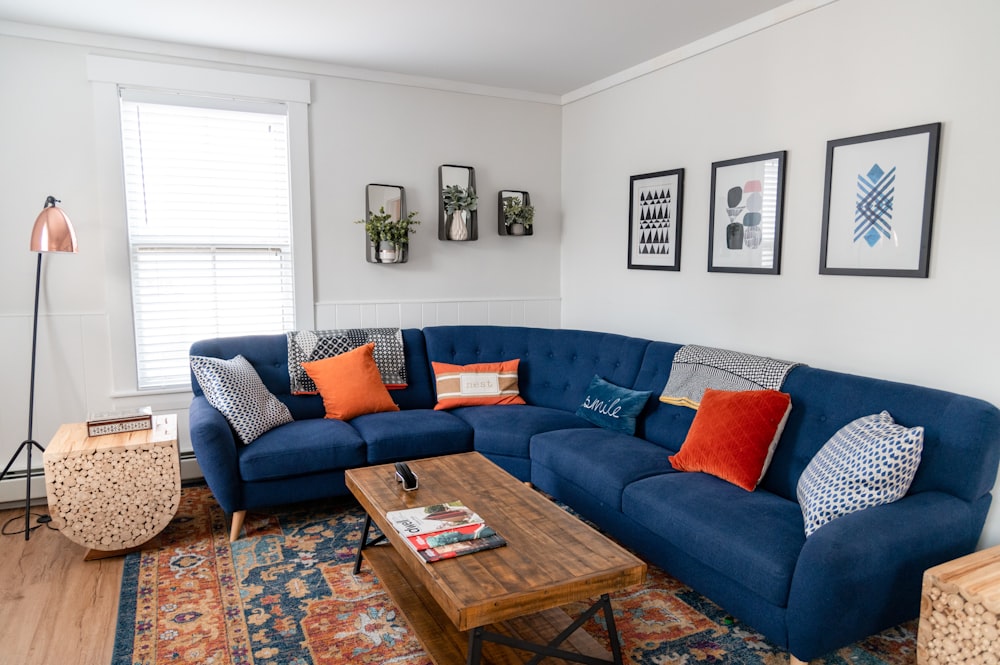 blue and brown couch with throw pillows