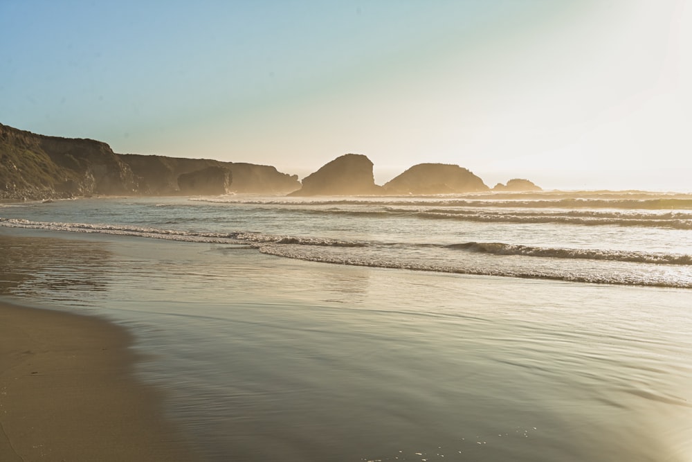 sea waves crashing on shore during daytime