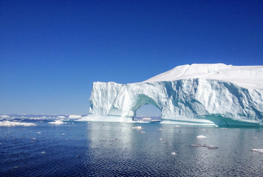 white ice formation on blue sea under blue sky during daytime