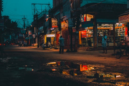 people walking on street during night time in West Bengal India