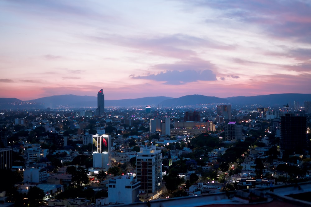 city skyline under cloudy sky during daytime