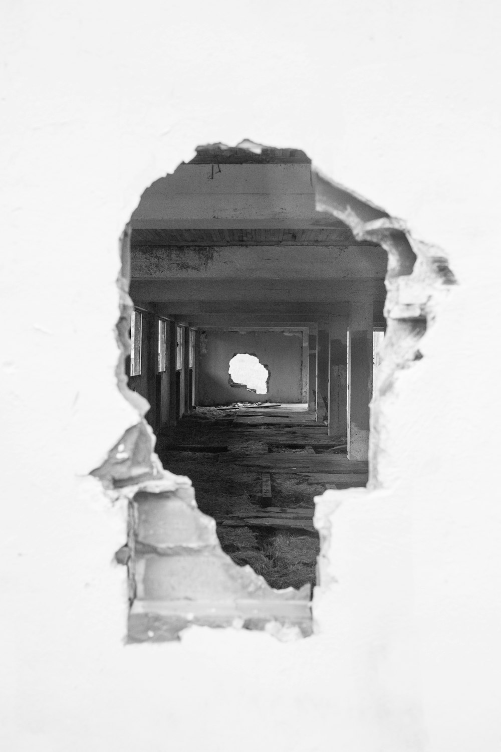 white concrete building with hole