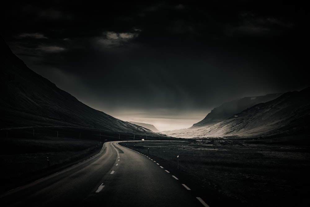 black asphalt road near mountain during daytime