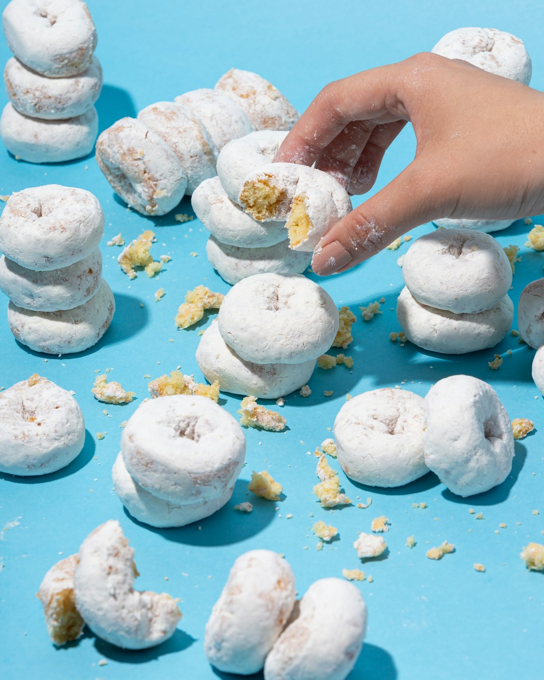 person holding white and brown round pastry