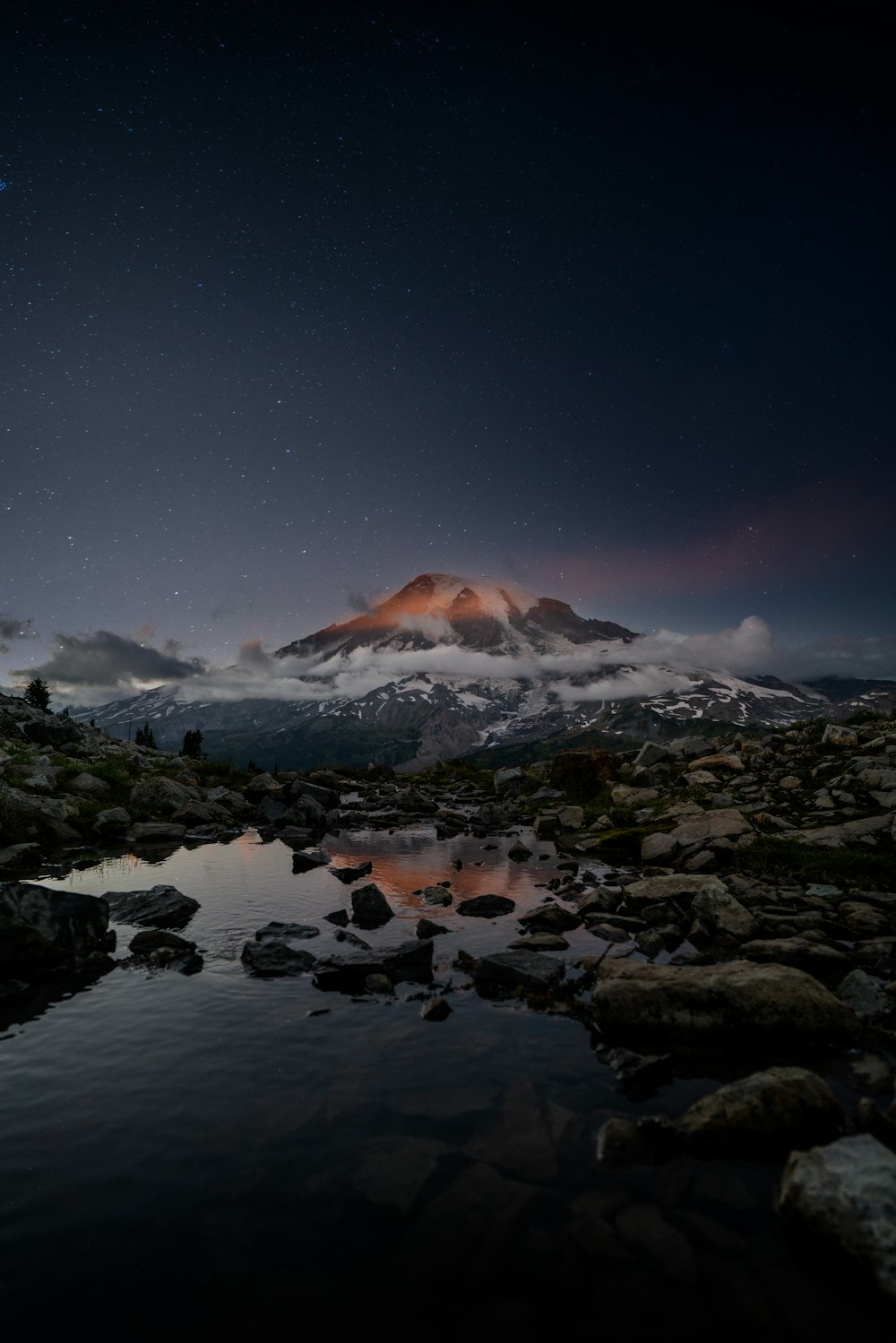 snow covered mountain during night time