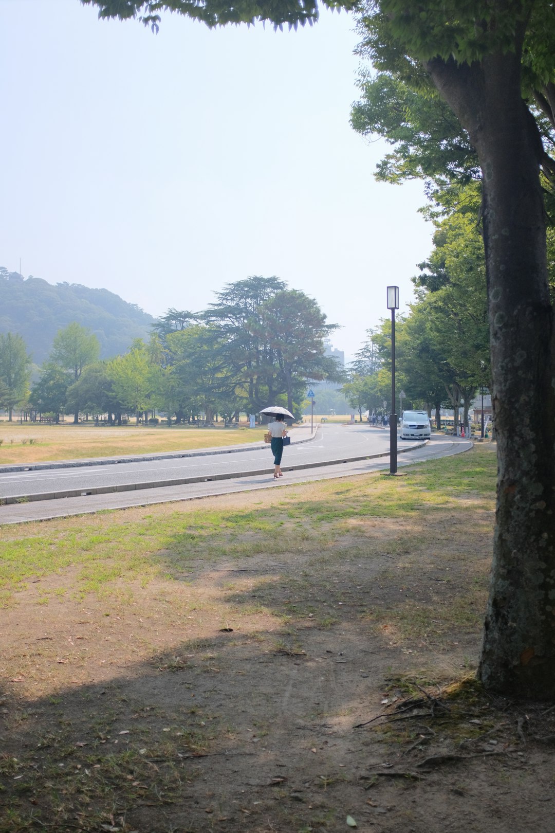 person walking on gray concrete road during daytime