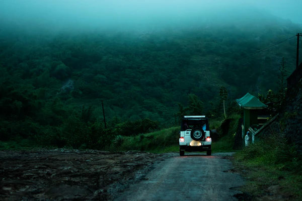 An SUV on a road through green countryside
