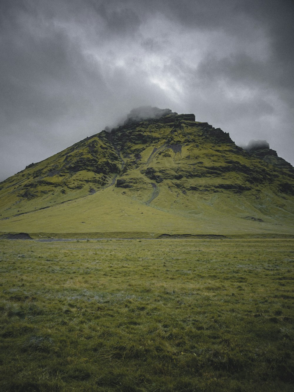 green and brown mountain under white clouds during daytime