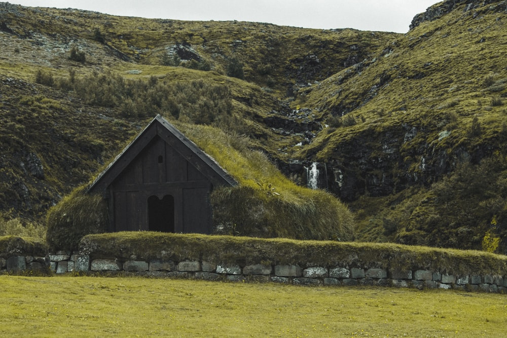 brown wooden house near mountain during daytime