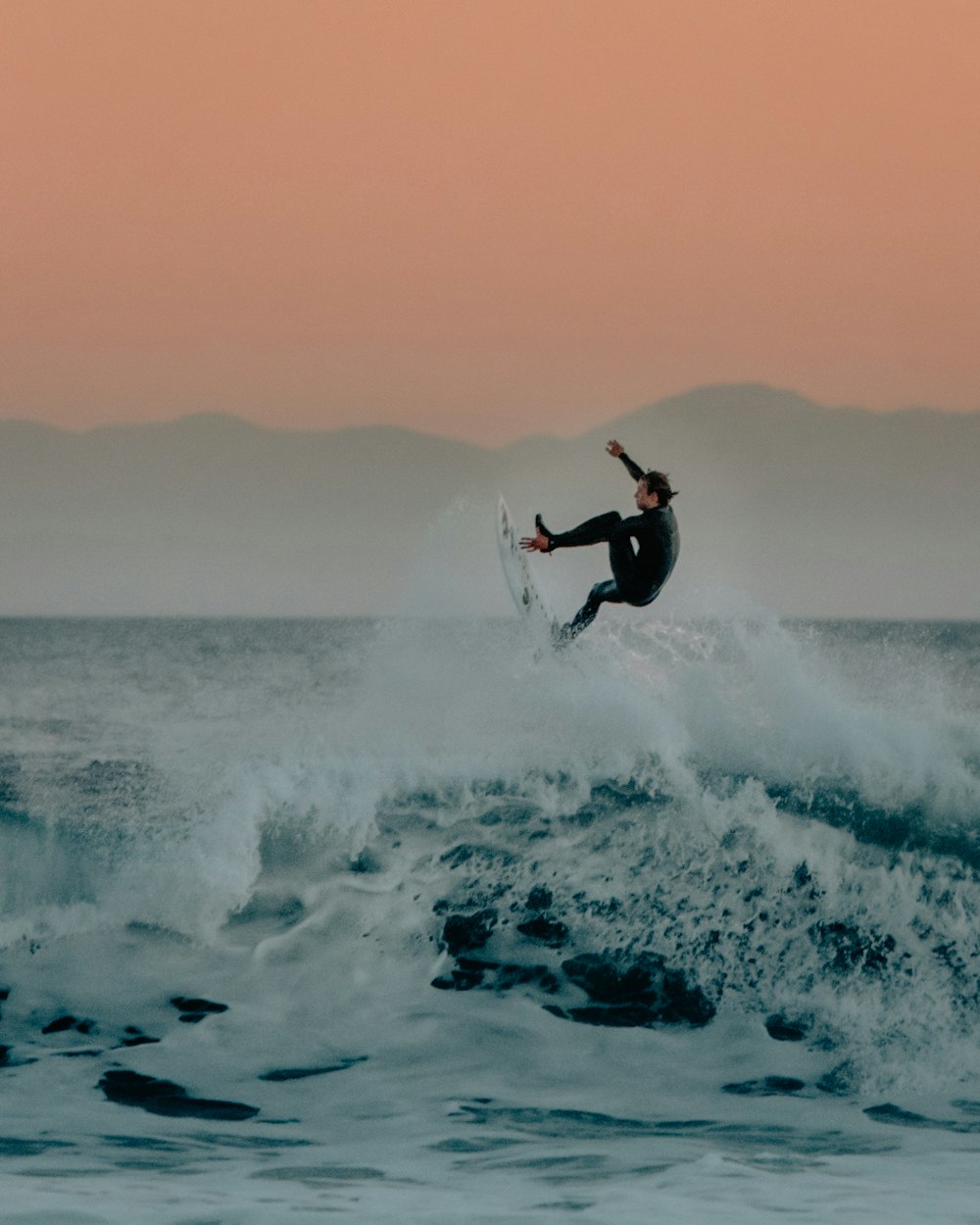 man surfing on sea waves during daytime