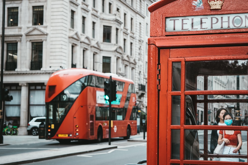 red and black double decker bus on road during daytime