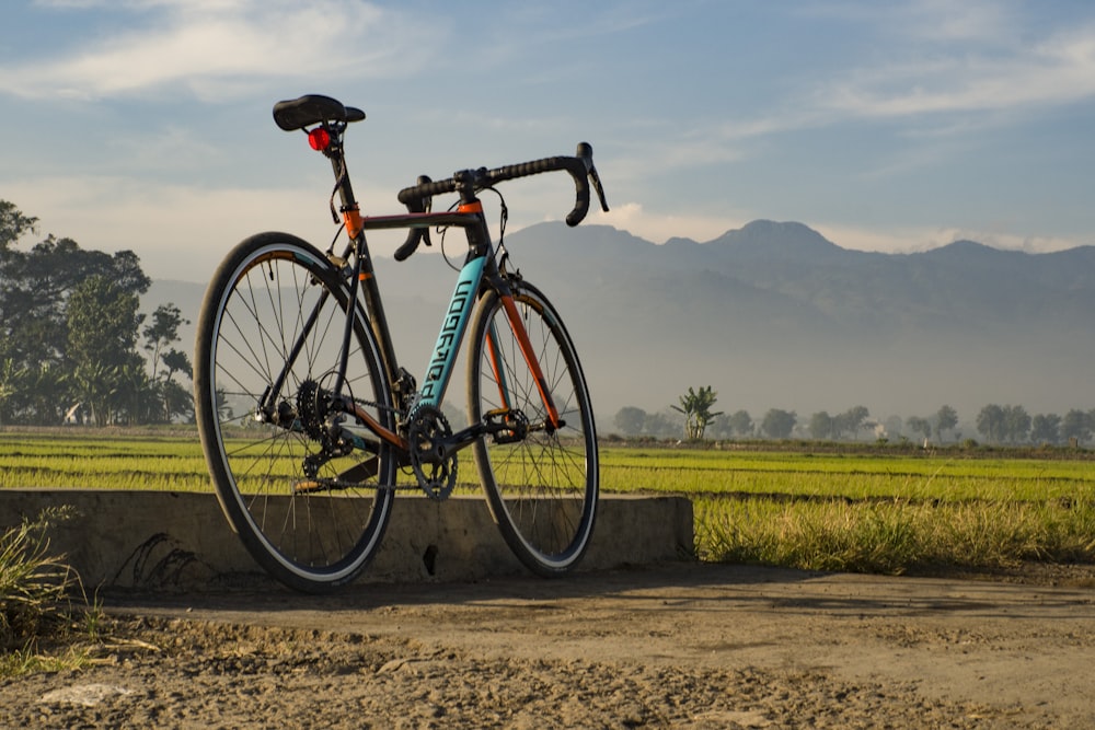 black and green mountain bike on brown dirt road during daytime