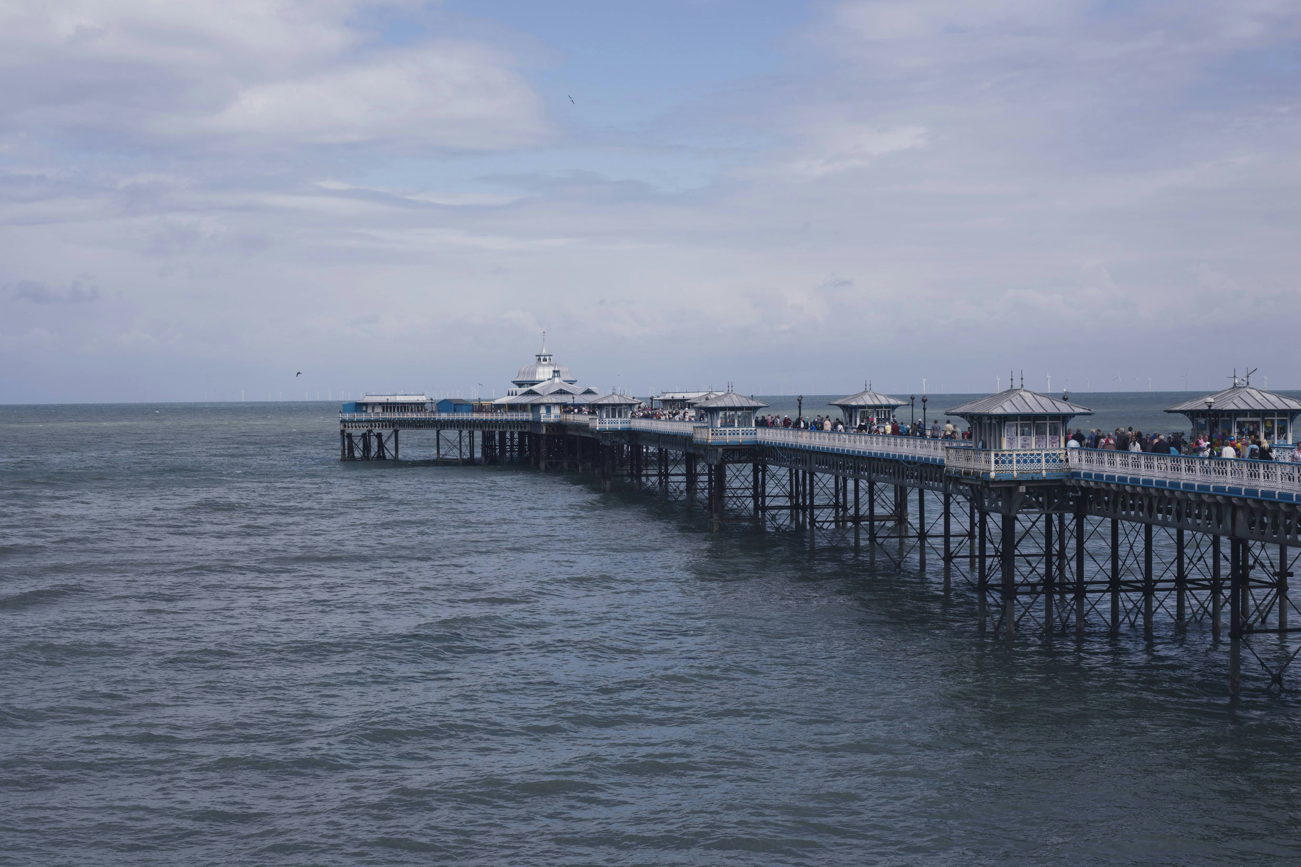 white and black wooden dock on sea under blue sky during daytime, Llandudno Pier 