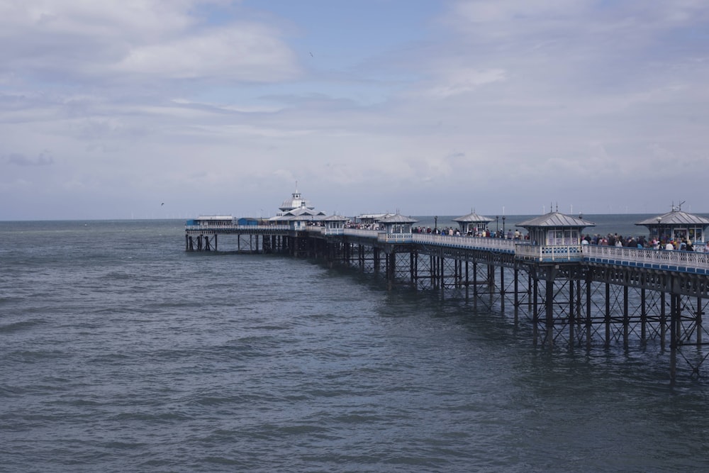 white and black wooden dock on sea under blue sky during daytime