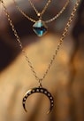 silver chain necklace with blue gemstone pendant