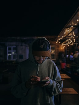 man in gray hoodie wearing black cap