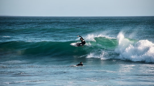 man surfing on sea waves during daytime in Hermanus South Africa