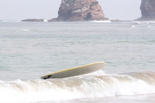 yellow surfboard on sea during daytime in Hendaye France