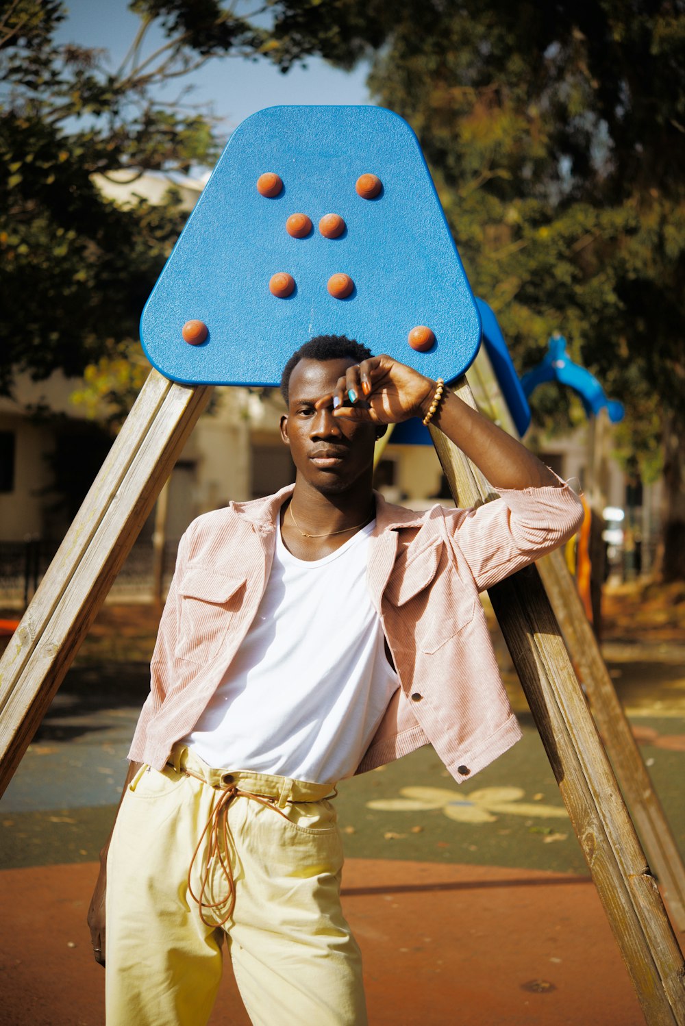 woman in white shirt holding blue and yellow polka dot balloon