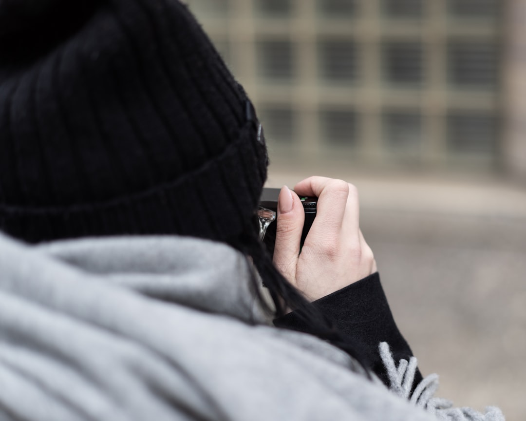 person in black knit cap and gray jacket