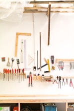 assorted hand tools on white table