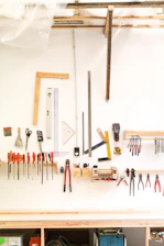 assorted hand tools on white table