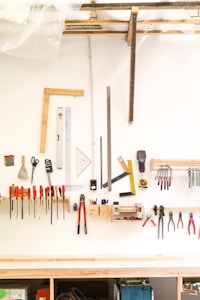 assorted hand tools on white table