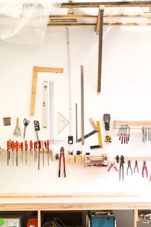 assorted hand tools on white table