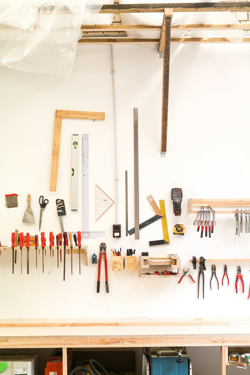 assorted hand tools on white table