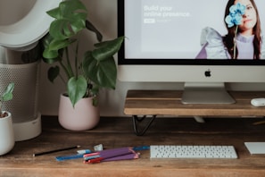 silver imac on brown wooden table