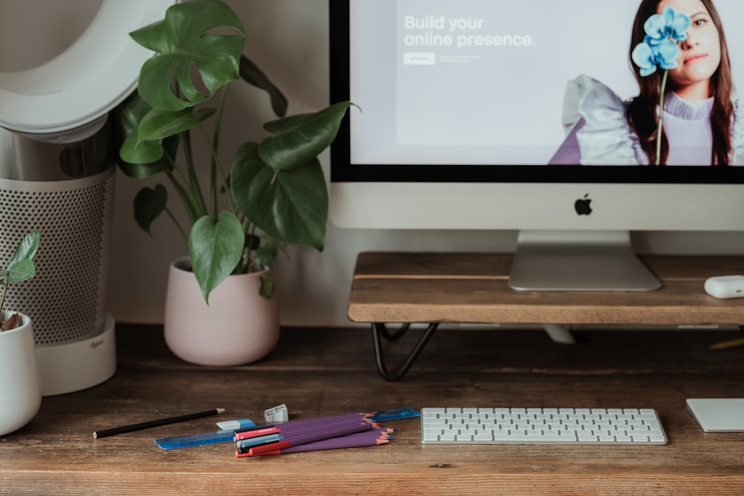 silver imac on brown wooden table