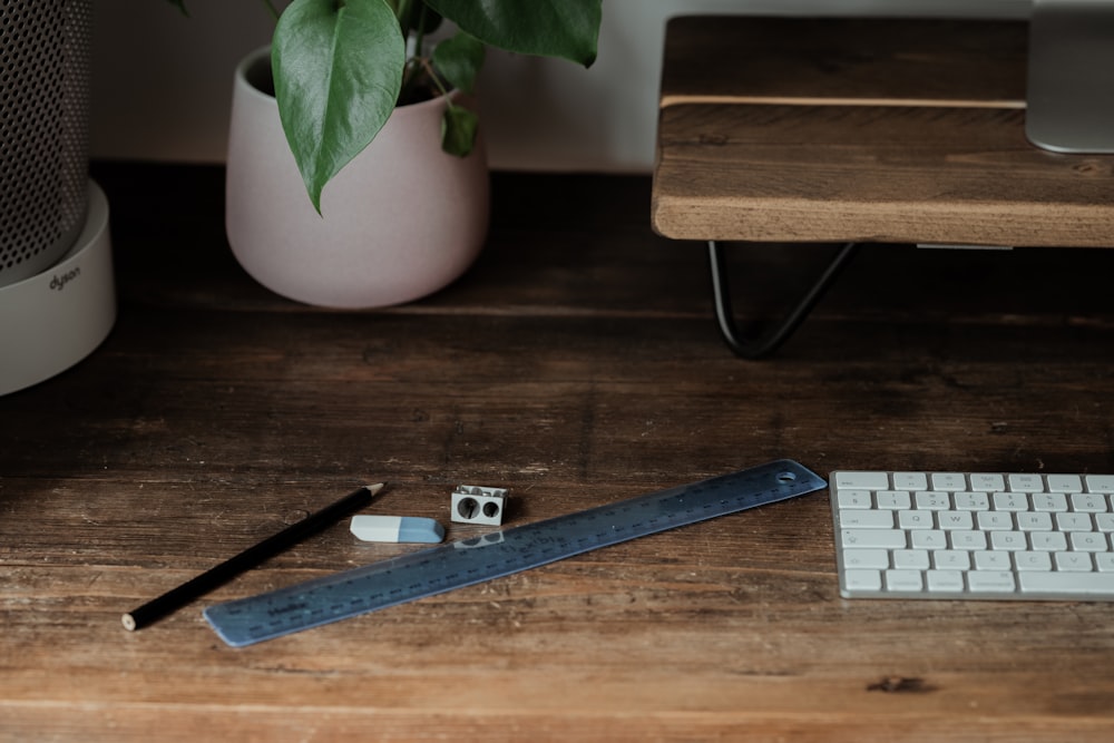 blue and silver ruler on brown wooden table