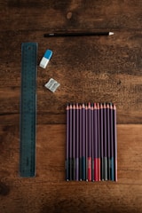 blue and white pencils on brown wooden table