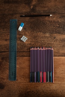 blue and white pencils on brown wooden table