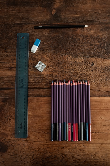 blue and white pencils on brown wooden table