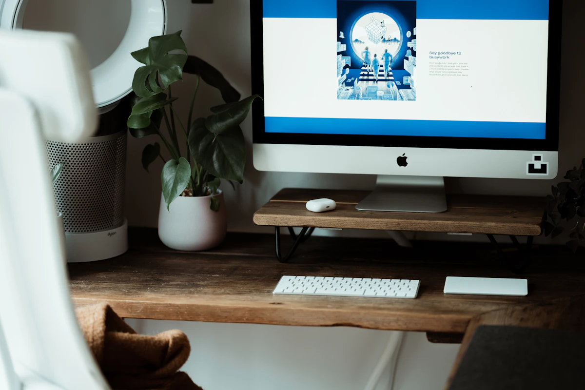 Silver imac on brown wooden table