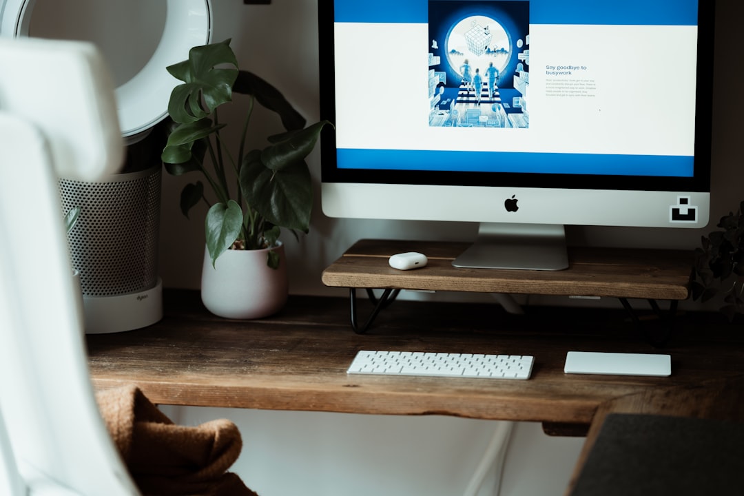 silver imac on brown wooden table