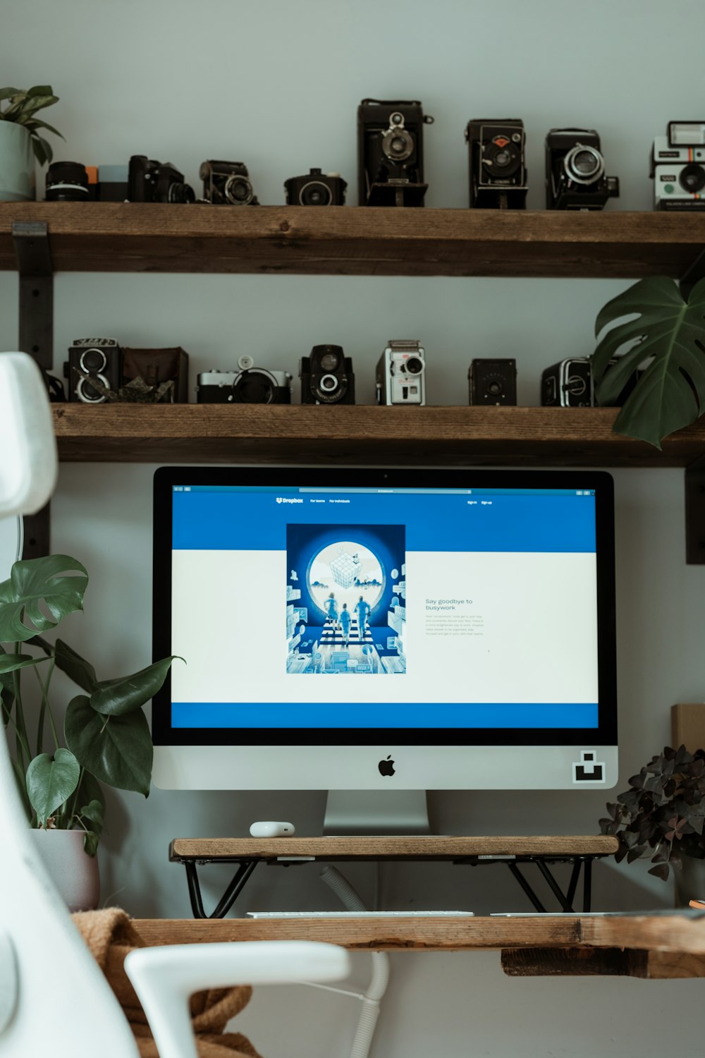 silver imac on brown wooden shelf